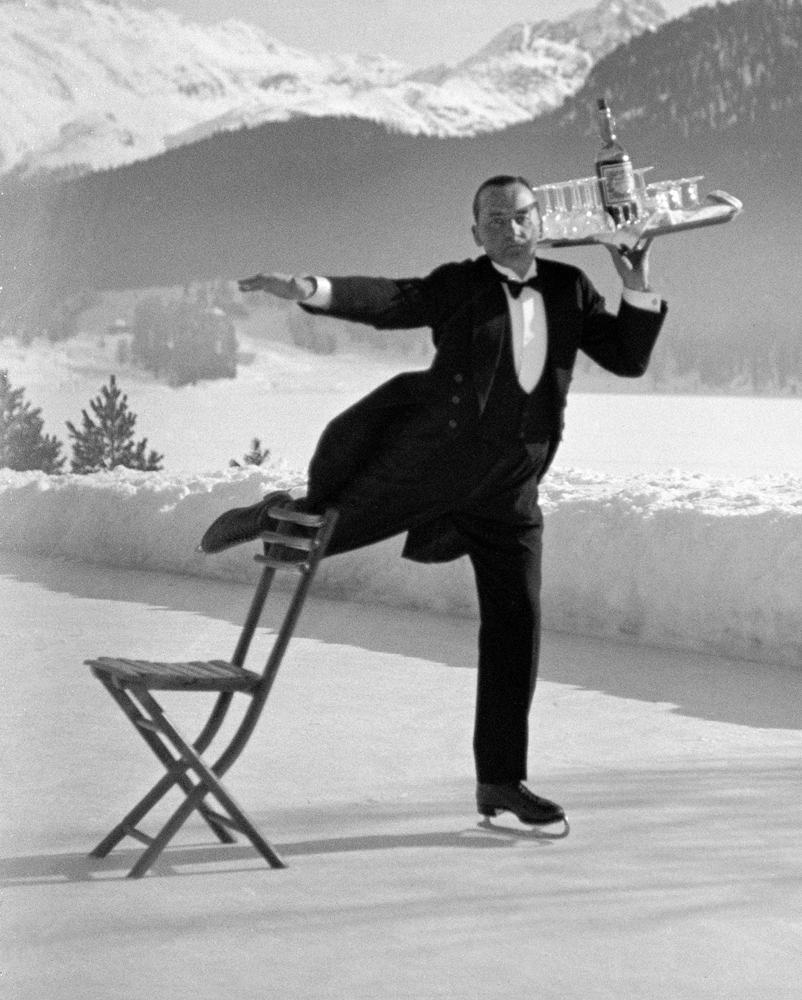 Skating waiter RenÂŽ Breguet delivers drinks at the Grand Hotel, St. Moritz, 1932.