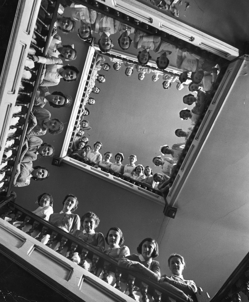 Student nurses line the railings of a stairwell at Roosevelt Hospital, New York, 1938.
